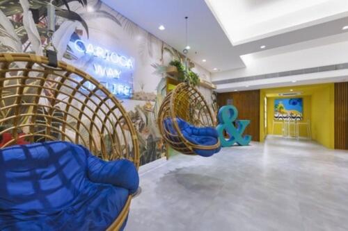 a room with chairs and a wall with a sign at B&B HOTEL Rio Copacabana Forte in Rio de Janeiro