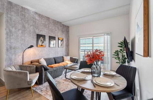 a living room with a table and a couch at Queen City Retreat - Parking, Views, Near Stadium in Charlotte