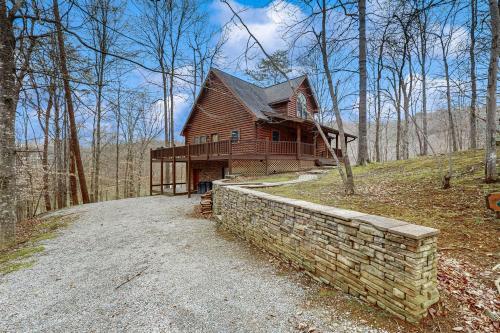 a log house on a hill in the woods at Other Side of the Mountain in New Tazewell