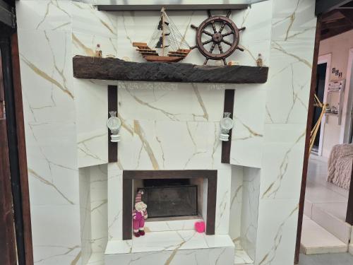 a fireplace with a ship on top of it at Pousada Cantinho da Tia Sandra in São Francisco do Sul