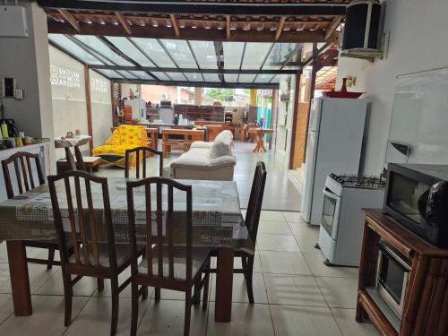 a kitchen and dining room with a table and chairs at Pousada Cantinho da Tia Sandra in São Francisco do Sul