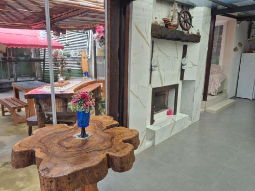 a room with a table with a vase of flowers on it at Pousada Cantinho da Tia Sandra in São Francisco do Sul
