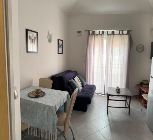a living room with a table and a couch at PRCPORTOapartmani in Herceg-Novi