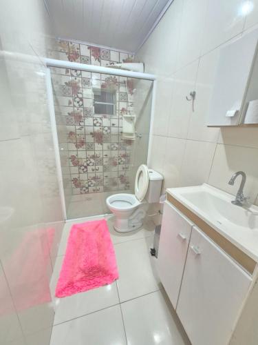 a bathroom with a shower and a toilet and a sink at Pousada Cantinho da Tia Sandra in São Francisco do Sul