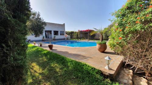 a swimming pool in the backyard of a house at Maison Mimosa, lovely 3 bedroom villa with a Large pool in Essaouira