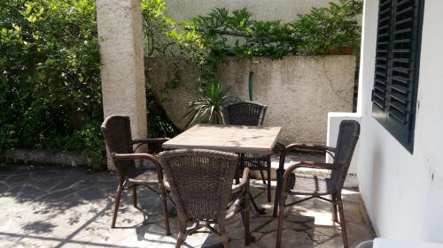 an outdoor table and chairs on a patio at PRCPORTOapartmani in Herceg-Novi