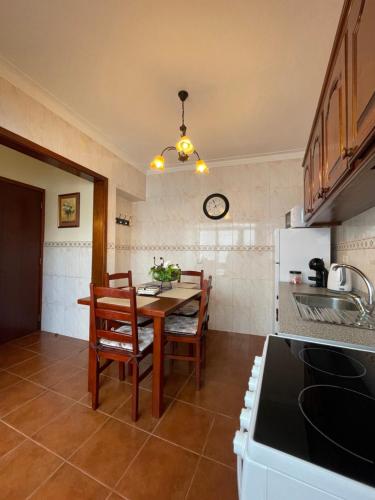 a kitchen with a table and chairs in a room at Casa São Salvador in Angra do Heroísmo