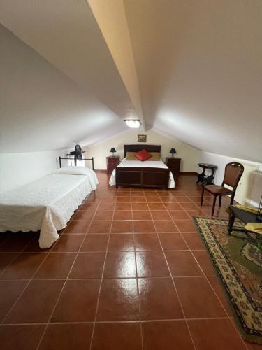 a bedroom with a bed and a tiled floor at Casa São Salvador in Angra do Heroísmo