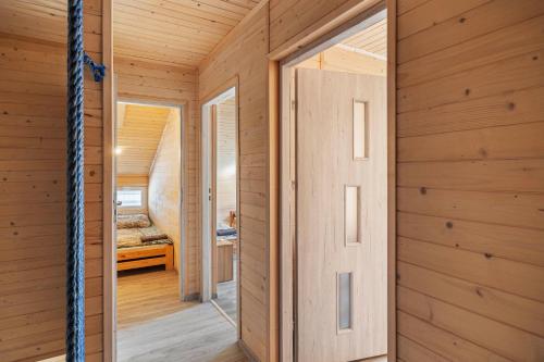 a wooden room with a door leading to a bedroom at Sielsko-Anielsko Kobyla Góra V in Ligota