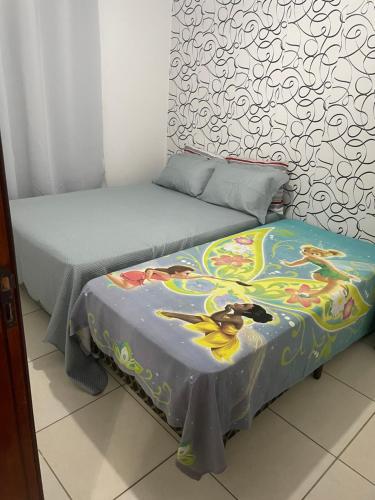 two beds sitting next to each other in a room at Jacumã AP in Conde