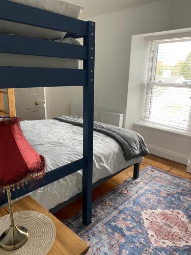 a bedroom with a blue bunk bed and a rug at No1 The Townhouse Kildare in Kildare