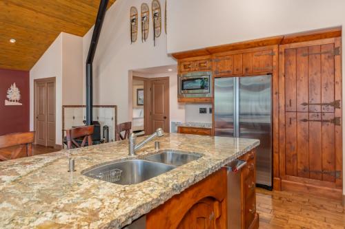 a kitchen with a sink and a refrigerator at Wilsons Roost in Dorrington