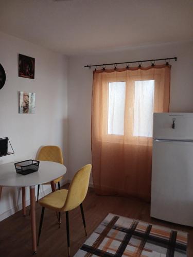 a kitchen with a table and chairs and a refrigerator at PRCPORTOapartmani in Herceg-Novi