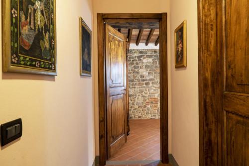 a hallway with a door and paintings on the walls at Country Historical House Lucca in San Gennaro