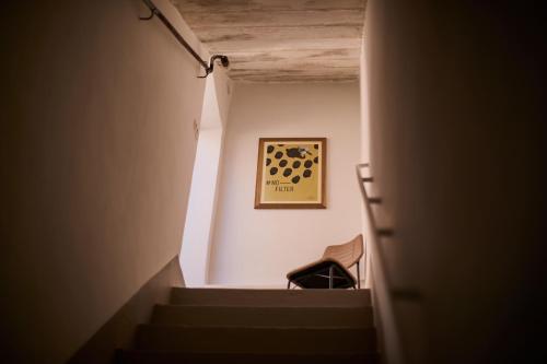 a hallway with stairs and a picture on the wall at B&B Casa Ninè in Gioia del Colle