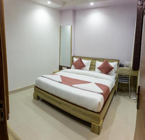 a bedroom with a large bed with pillows on it at Hotel Neu-Nest inn in Rishīkesh