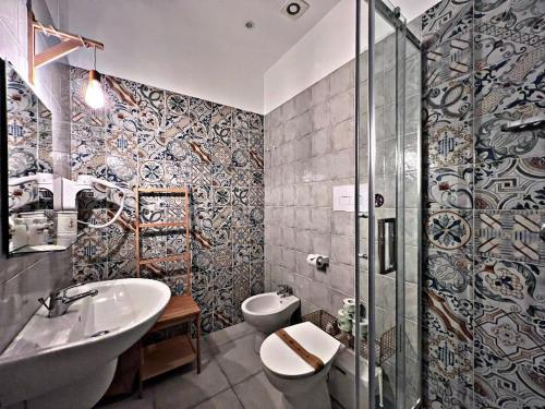 a bathroom with a sink and a toilet and a shower at Io.te e il mare in Termoli