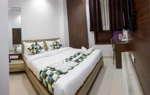 a bedroom with a large bed with bows on it at Hotel Neu-Nest inn in Rishīkesh