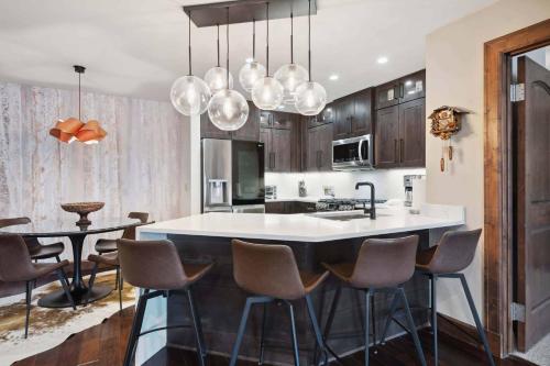 a kitchen with a large white island in a room at Ascent 312 by East West Hospitality in Avon