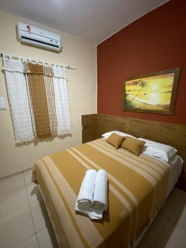Postel nebo postele na pokoji v ubytování Residencial Dragão