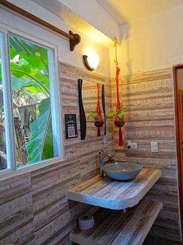 a bathroom with a sink and a window at Prima Luna Palomino in Palomino