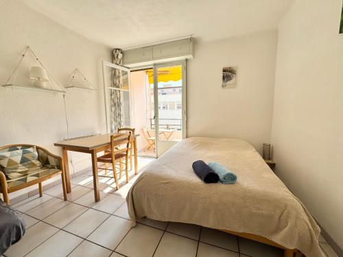 une chambre avec un lit et une table et une salle à manger dans l'établissement L'helios studio au calme centre et mer, à Vallauris