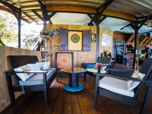 a living room with chairs and a table and a table at El Caribeo in Bocas Town