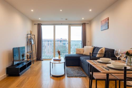 a living room with a couch and a table at K Suites - Rivington Apartments in Slough
