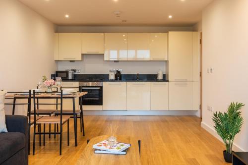 a kitchen and living room with a couch and a table at K Suites - Rivington Apartments in Slough