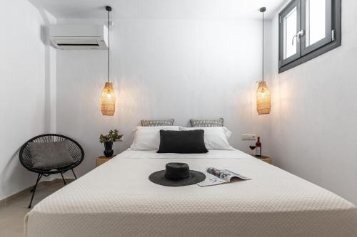 a bedroom with a bed with a hat on it at plaka riviera villa in Naxos Chora