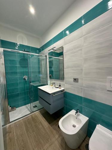 a bathroom with a sink and a shower and a toilet at Karim's House in Portici