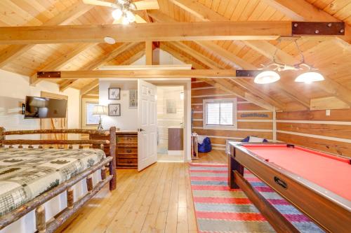 a room with a bed and a pool table at True Log Cabin with Game Room, Year-Round Views in Waynesville