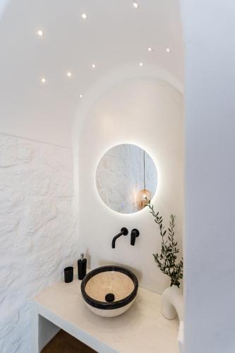 a bathroom with a sink and a mirror at plaka riviera villa in Naxos Chora