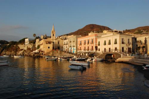 a group of boats in a river with buildings at Residence Hotel Villa Fiorentino in Lipari