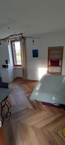 a bedroom with a bed and a wooden floor at Studio Salavas in Salavas