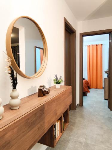 a bathroom with a large mirror and a wooden counter at Amber Court Apartment in Marsaskala