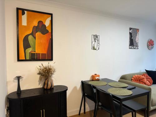 a living room with a table and a couch at Stylish One Bedroom Apartment in Edinburgh