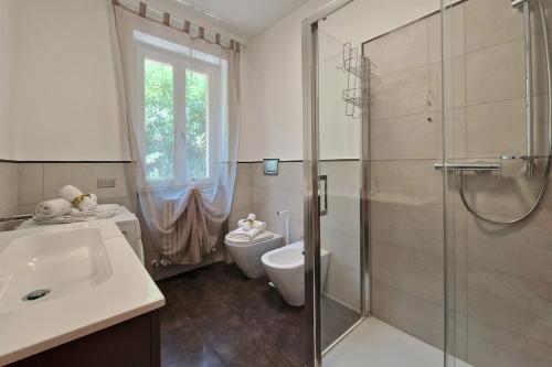 a bathroom with a shower and a toilet and a sink at Double Sea View Design Wi-Fi Parking AC in Fermo