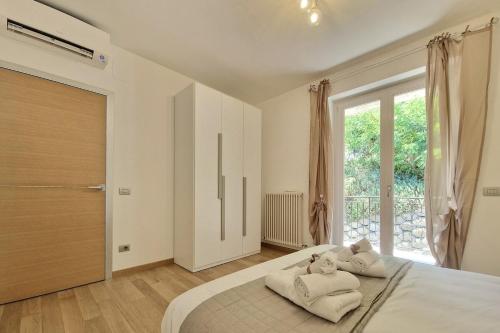 a bedroom with a large bed with towels on it at Double Sea View Design Wi-Fi Parking AC in Fermo