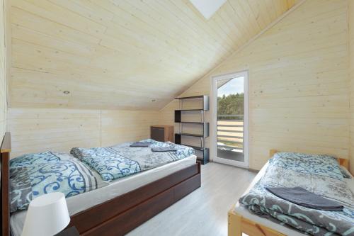 a bedroom with two beds and a window at Sielsko-Anielsko Kobyla Góra I in Ligota
