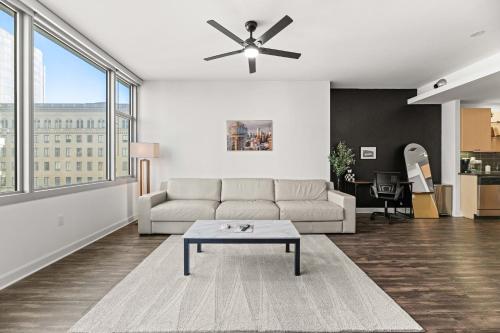 a living room with a couch and a ceiling fan at Modern Downtown Dallas City View High-Rise with Balcony, Gym, Pool, Free Parking 7th Floor in Dallas