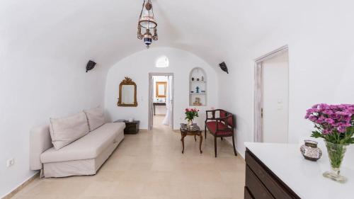 a white living room with a couch and a table at Athinais Mansion in Megalokhori