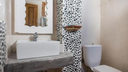 a bathroom with a white sink and a toilet at Athinais Mansion in Megalokhori