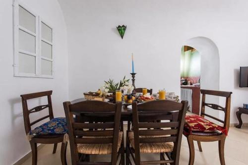 a dining room with a table and four chairs at Athinais Mansion in Megalokhori