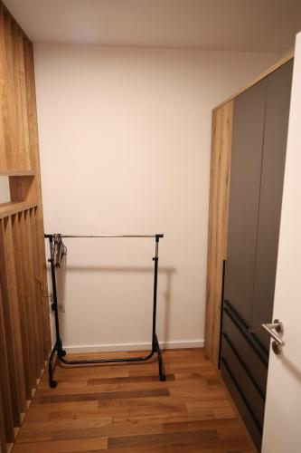 a room with a white wall next to a door at Apartment Story Nis in Niš
