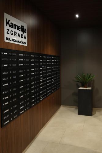 a room with a wall of wine bottles at Apartment Story Nis in Niš