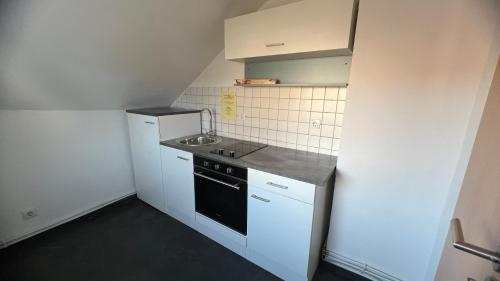 a small kitchen with a sink and a stove at Ferienwohnung in Wesel