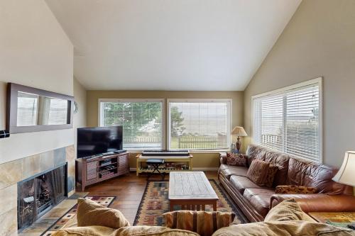 a living room with a couch and a fireplace at Bayview Escape in Lincoln City