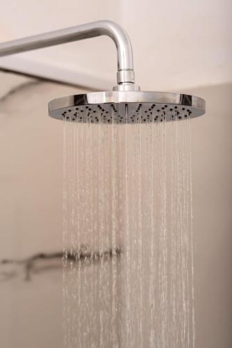 a shower head with water dripping from it at The Z House Santorini in Fira