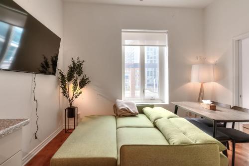 a living room with a couch and a table at Fox Aparthotel Palais Des Congres IV in Montréal